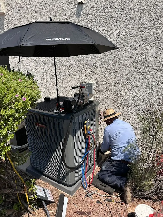 HVAC technician performing outdoor AC maintenance in Rockport